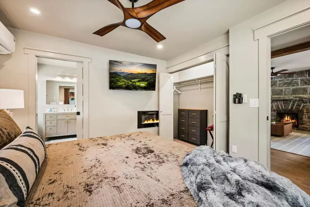 Guest-ready bedroom suite with fireplace and plush layered bedding