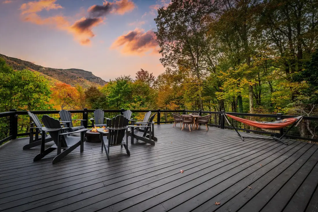 New mountain deck at sunset with fire pit seating and a hammock