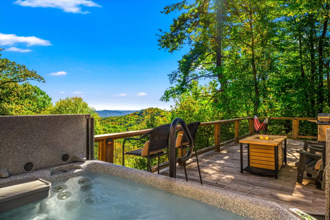 Bubbling hot tub on a dome deck with long-range mountain views