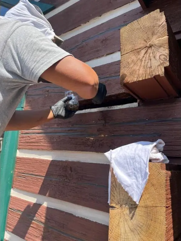 Pro repairing and sealing log cabin exterior walls