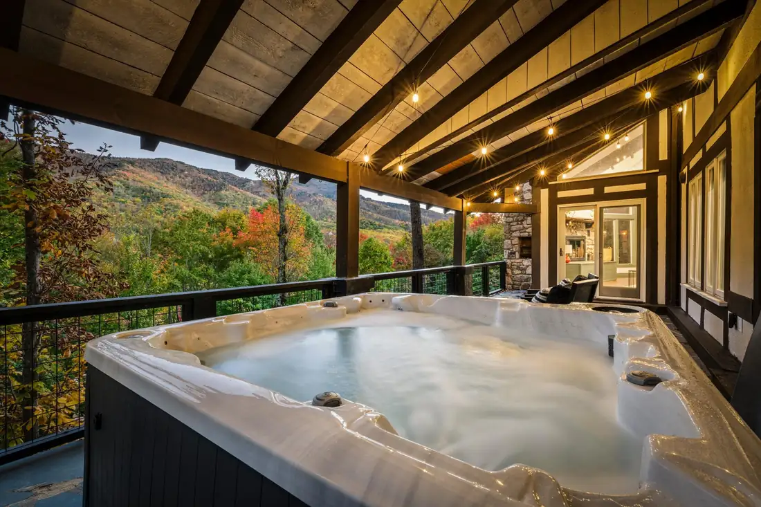 Guest-ready covered porch with hot tub and long-range mountain view