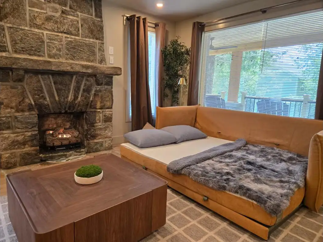 Stone fireplace lounge with daybed kept guest-ready
